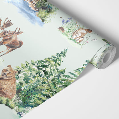 Roll of wallpaper with forest animals design on a pale green background
