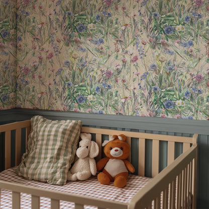 cot with check bedding and a floral wallpapered wall
