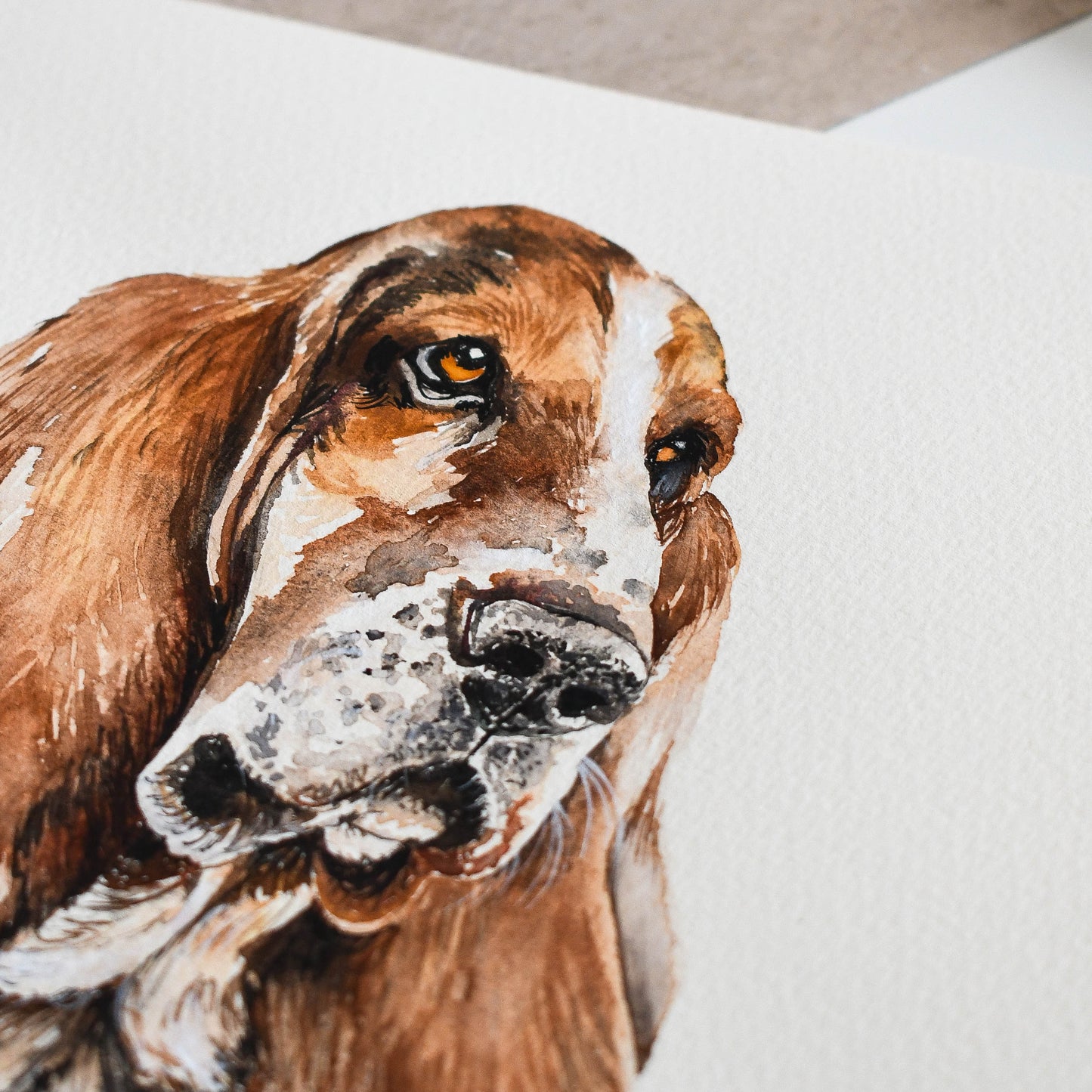 Close-up of a detailed painting of a dog's face on a textured surface.