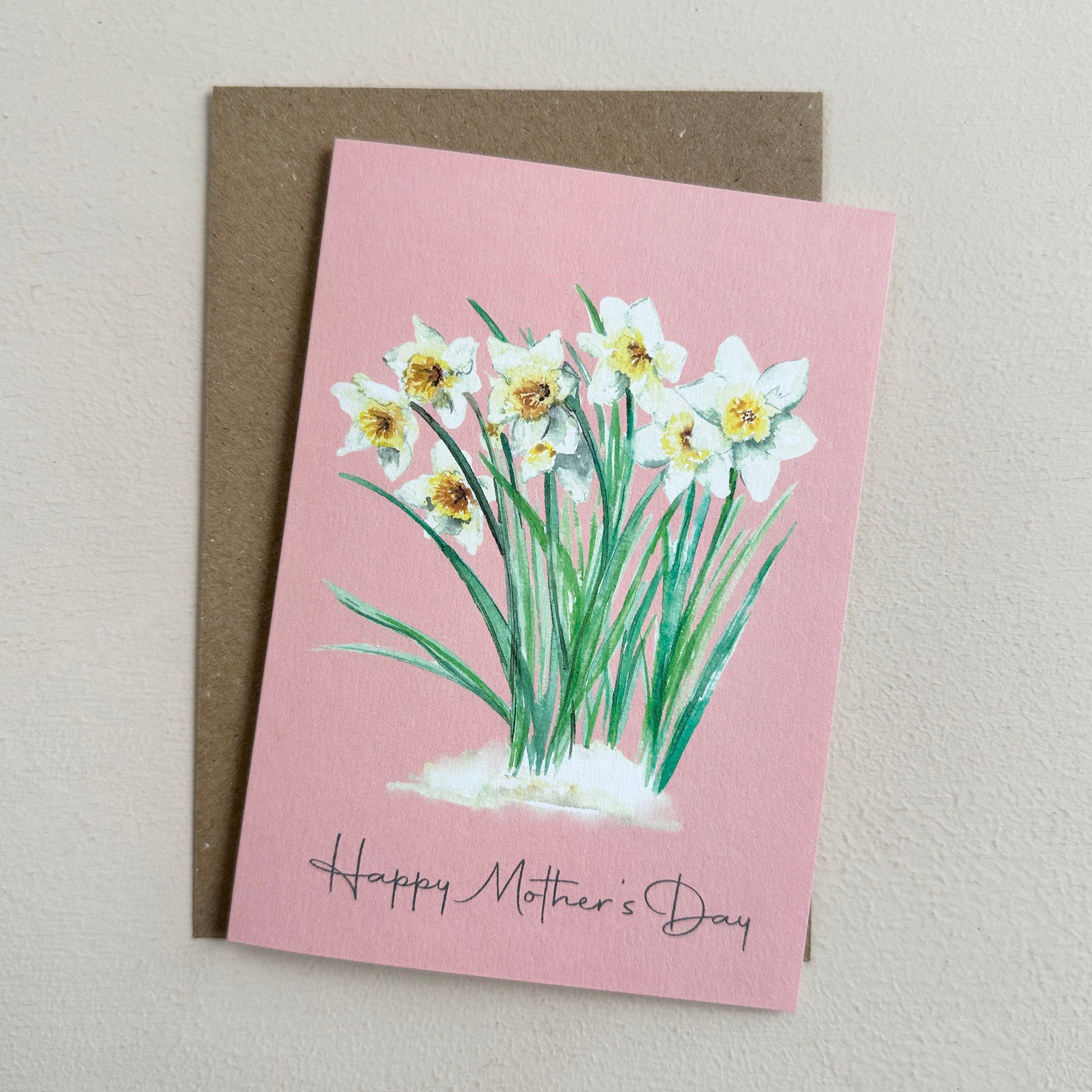 Greeting card with daffodil illustration and 'Happy Mother's Day' text on a pink background.